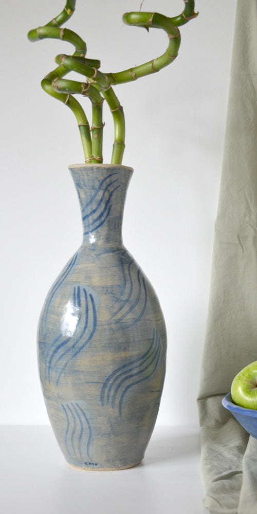 Tall blub vase in a pale glossy gaze with light blu painted design