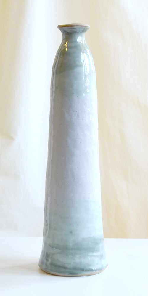 Tall slim jar style vase in glossy white with copper green detail